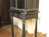 a small black table with a mirror on top of it