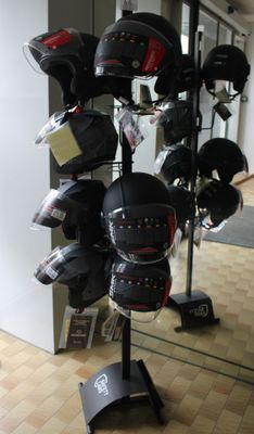 a display of helmets on a stand in a room