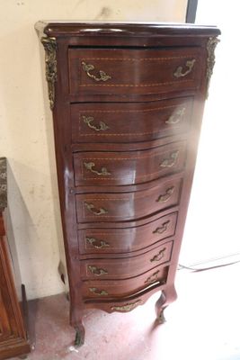 a wooden chest of drawers with a mirror on top of it