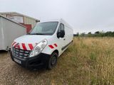 a white van parked in a field with a red and white stripe on it