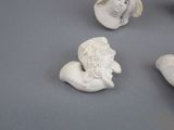 three white ceramic figurines of women with hats and hats on them