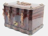 a small wooden box with brass handles on a white background