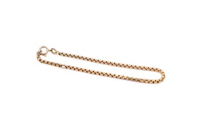 a close up of a gold chain on a white background