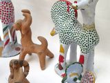 five figurines of different shapes and sizes on a white surface
