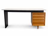 a black and white desk with a wooden drawer underneath it