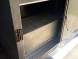a metal cabinet with a door open on the floor