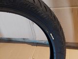 a tire that is sitting on the floor next to a box