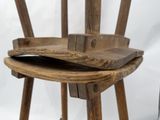 a wooden chair that has a wooden seat on top of it