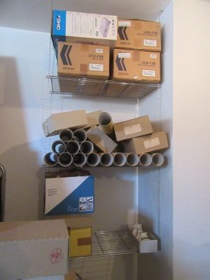 a closet with a lot of boxes and boxes on the shelves