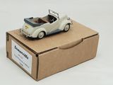 a small toy car sitting on top of a cardboard box