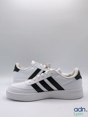 a white and black adidas sneakers on a white background