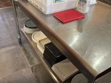 a large metal table with a bunch of dishes on it