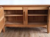 a wooden cabinet with two doors open on the floor