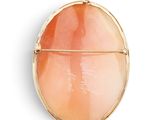 an image of a gold locke with a pink stone in the center