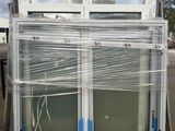 two windows that are wrapped in plastic on the back of a truck