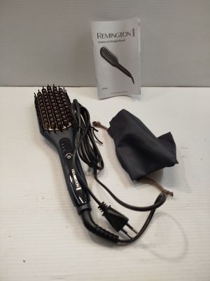an image of a hair dryer and brush on a table