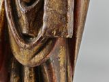 a close up of a statue of a man holding a book
