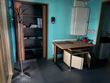 a room with a desk and a cabinet in it