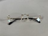 pair of glasses on a table with a white table cloth