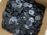 a cardboard box filled with black and gray plastic parts