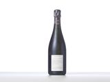 a bottle of wine sitting on top of a white table
