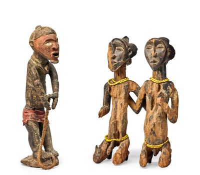three wooden figurines of people standing next to each other on a white surface