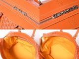 an orange purse with a zipper on the inside and a zipper on the outside
