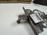 a metal latch that is sitting on a table