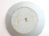a white plate with a brown spot on it