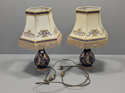 pair of blue and white lamps with gold fringes and a blue and white lamp shade