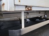 a close up of a flatbed truck with rust on the side