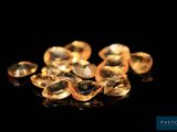 un gros plan sur un bouquet de diamants jaunes posés sur une surface noire