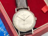 a silver watch in a red box on a table