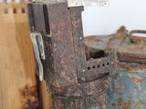 a rusted metal object sitting on top of a pile of rusty containers