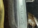 a close up of a sewing machine with a brass handle