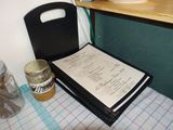 a menu and a jar of honey on a table