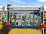 many different types of tractors parked in a lot