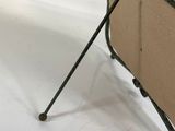 a chair that is sitting on a metal stand