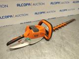a close up of a chainsaw sitting on a table in front of a wall
