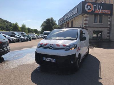a small white van parked in front of a building