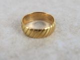 a close up of a gold ring on a white surface