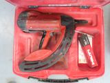 a tool in a red case that is sitting on a table