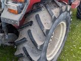 a tractor that is parked on the grass in the yard