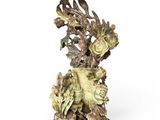 statue of a bird and flowers on a wooden base on a white background