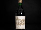 a bottle of wine sitting on top of a black table