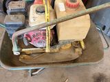 a wheelbarrow with tools in it in a garage