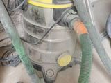 an image of a vacuum and a hose in a room