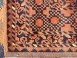 an orange and blue area rug with a pattern on it