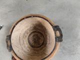 a picture of a wooden bowl with tools on the floor