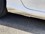 a close up of a white car with a flat tire